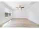 Bright and spacious bedroom featuring wood flooring, a ceiling fan, and a large window at 314 Adams St, Salisbury, NC 28144