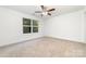 Spacious bedroom with a ceiling fan, neutral carpet, and a large window at 314 Adams St, Salisbury, NC 28144