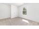 Bedroom features neutral carpet and a sunlit window at 314 Adams St, Salisbury, NC 28144