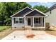 Charming single Gathering home features a covered porch, gray siding, and a concrete driveway at 314 Adams St, Salisbury, NC 28144