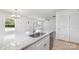 Modern kitchen showcases granite countertops and stainless steel appliances overlooking an open living area at 314 Adams St, Salisbury, NC 28144
