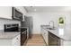 Bright kitchen features granite countertops, stainless steel appliances and white cabinetry at 314 Adams St, Salisbury, NC 28144