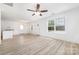 Open-concept living room boasts hardwood floors, natural light, and fresh, neutral paint at 314 Adams St, Salisbury, NC 28144
