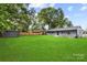 Large backyard with a storage shed, a wooden fence, and green grass at 316 Fulton St, Kings Mountain, NC 28086