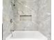 Elegant bathroom featuring stylish marble tiling, a sleek bathtub, and a convenient recessed shelf at 316 Fulton St, Kings Mountain, NC 28086
