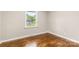 This cozy bedroom features hardwood floors, fresh paint and a backyard view at 316 Fulton St, Kings Mountain, NC 28086