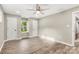 Bright bedroom with a ceiling fan, neutral walls, wood look floors, and ample closet space at 316 Fulton St, Kings Mountain, NC 28086