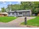 Charming home features a lush lawn, gray-painted brick, and a paved driveway at 316 Fulton St, Kings Mountain, NC 28086