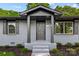 Charming home with a gray brick exterior, black trim, and lush landscaping at 316 Fulton St, Kings Mountain, NC 28086