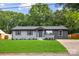 Charming one-story home has a manicured lawn with gray-painted brick at 316 Fulton St, Kings Mountain, NC 28086