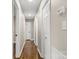 Long hallway with hardwood flooring, fresh paint and white doors at 316 Fulton St, Kings Mountain, NC 28086