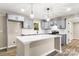This kitchen features gray cabinets, stainless steel appliances, white countertops, and a central island at 316 Fulton St, Kings Mountain, NC 28086