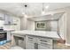 Beautiful kitchen with island, gray cabinets, white countertops, stainless appliances, and wood floors at 316 Fulton St, Kings Mountain, NC 28086