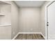 A freshly painted room boasts wood-look vinyl flooring and a conveniently placed front door at 316 Fulton St, Kings Mountain, NC 28086