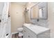 Cozy bathroom features modern sink, toilet and tiled shower in neutral colors at 319 Leonard Ave, Albemarle, NC 28001