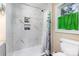 Bright bathroom featuring marble-style tiled shower and storage niches at 319 Leonard Ave, Albemarle, NC 28001