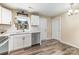 Bright kitchen with white cabinets, stainless steel appliances, and wood-look flooring at 319 Leonard Ave, Albemarle, NC 28001