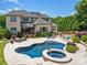 Aerial view of the home featuring a large backyard with a pool, patio, and lush landscaping at 324 Squash Harvest Ct, Matthews, NC 28104