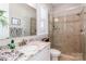 Modern bathroom with granite countertops, a glass-enclosed shower, and ample natural light at 324 Squash Harvest Ct, Matthews, NC 28104