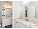 Well-lit bathroom with granite countertops and double vanity mirrors for two separate sinks at 324 Squash Harvest Ct, Matthews, NC 28104