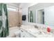 Bright bathroom featuring a granite vanity, shower-tub with tile surround, and a decorative shower curtain at 324 Squash Harvest Ct, Matthews, NC 28104
