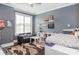 Cozy bedroom with large window, grey walls, hardwood floors, and ceiling fan at 324 Squash Harvest Ct, Matthews, NC 28104