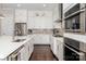 Contemporary kitchen with white cabinets, stainless steel appliances, and a large island with ample counter space at 324 Squash Harvest Ct, Matthews, NC 28104