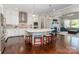 Gourmet kitchen featuring a large island with seating, white cabinetry, and seamless flow to living area at 324 Squash Harvest Ct, Matthews, NC 28104