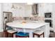 Modern kitchen featuring white cabinetry, stainless steel appliances, and a spacious island with barstool seating at 324 Squash Harvest Ct, Matthews, NC 28104