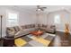 Comfortable living room features a plush sectional sofa, hardwood floors, and plenty of natural light at 324 Squash Harvest Ct, Matthews, NC 28104