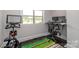 Bright office space with a standing desk and workout bike at 324 Squash Harvest Ct, Matthews, NC 28104