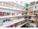 Walk-in pantry features bright lighting, ample shelving, and well-organized storage for all of your goods at 324 Squash Harvest Ct, Matthews, NC 28104