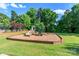 Charming playground area with a slide and various climbing structures, set in a grassy area with trees at 324 Squash Harvest Ct, Matthews, NC 28104