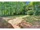 Wide backyard area with mature trees and natural setting at 331 Glen Oaks Rd, Charlotte, NC 28270