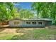 Backyard view showing the back of the home and surrounding landscape at 331 Glen Oaks Rd, Charlotte, NC 28270