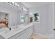 Bright bathroom featuring a double sink vanity with large mirror and ample natural light at 331 Glen Oaks Rd, Charlotte, NC 28270