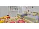 Bright bedroom featuring twin beds, colorful rug, and plenty of natural light at 331 Glen Oaks Rd, Charlotte, NC 28270