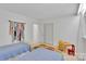 Well-lit bedroom featuring twin beds, white walls, and closet storage at 331 Glen Oaks Rd, Charlotte, NC 28270