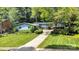 Beautiful exterior of home featuring lush landscaping, green lawn, and a welcoming yellow front door at 331 Glen Oaks Rd, Charlotte, NC 28270