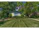 Exterior of single-story home with mature trees, and green lawn at 331 Glen Oaks Rd, Charlotte, NC 28270