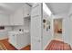 Hallway with white cabinets and brick flooring leading to a room with neutral-colored walls at 331 Glen Oaks Rd, Charlotte, NC 28270