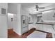Open kitchen with white cabinets, brick floors, and stainless-steel refrigerator at 331 Glen Oaks Rd, Charlotte, NC 28270