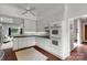 Charming kitchen featuring white cabinets, modern appliances, and unique brick flooring at 331 Glen Oaks Rd, Charlotte, NC 28270