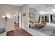 View of the light and airy living room featuring wood paneled walls and a brick hallway at 331 Glen Oaks Rd, Charlotte, NC 28270