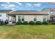 Neat backyard showcasing a well-kept lawn, tidy shrubbery, and a screened-in porch for outdoor enjoyment at 333 Dudley Dr, Fort Mill, SC 29715