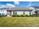 Spacious backyard with lush green grass, a fenced perimeter, and a view of the home's exterior at 333 Dudley Dr, Fort Mill, SC 29715