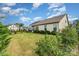 Expansive backyard with manicured lawn, lovely shrubbery, complemented by neighboring houses under a partly cloudy sky at 333 Dudley Dr, Fort Mill, SC 29715
