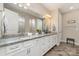 Spacious bathroom featuring double sinks, granite countertops, white cabinetry and a large mirror at 333 Dudley Dr, Fort Mill, SC 29715