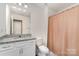 Well-lit bathroom with granite-topped vanity, a large mirror, and shower with a curtain at 333 Dudley Dr, Fort Mill, SC 29715