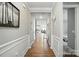 Bright hallway with hardwood floors, decorative molding, and an open doorway leading to another room at 333 Dudley Dr, Fort Mill, SC 29715